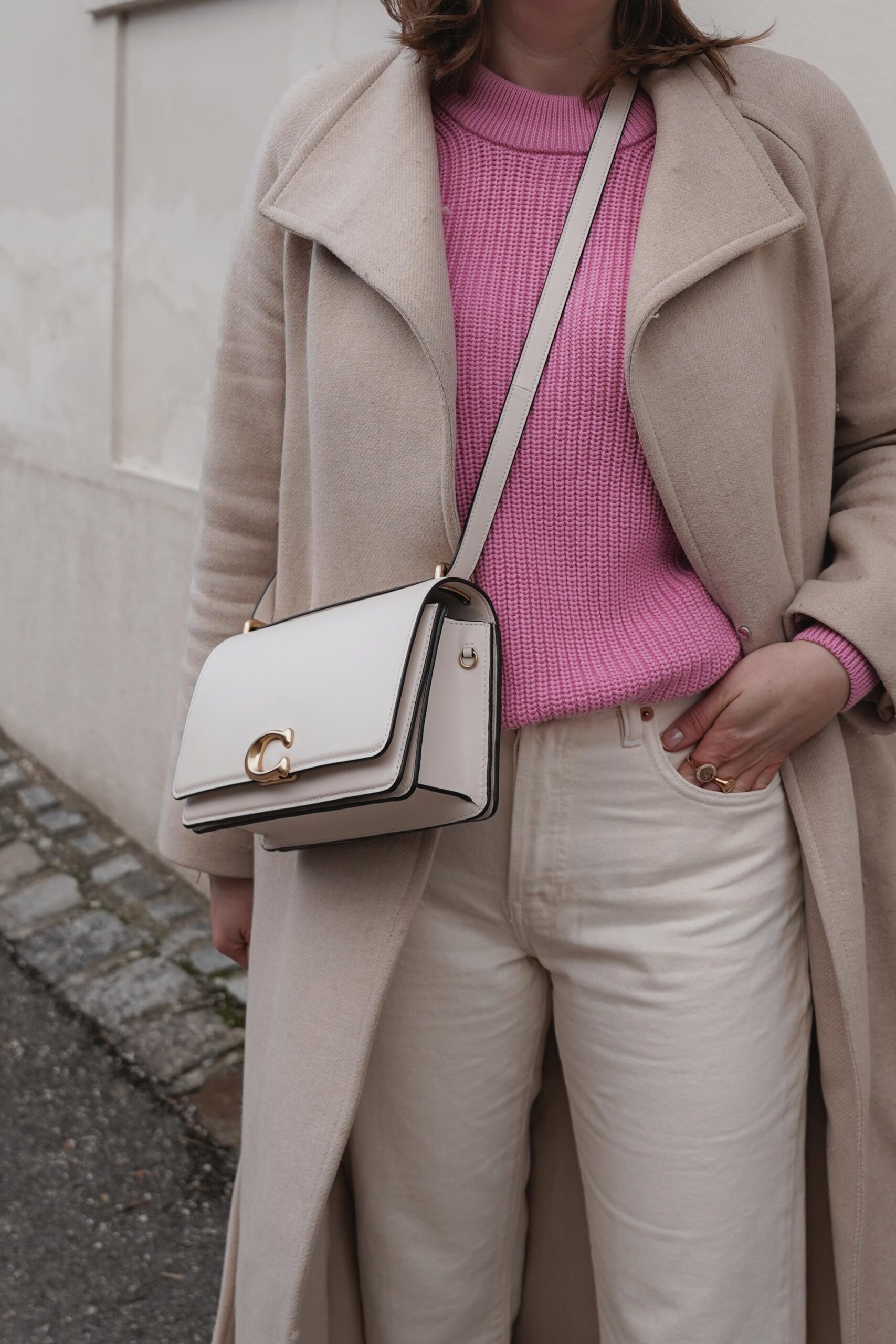 flared jeans, pink sweater, beige winter coat, mango, coach bag, casual