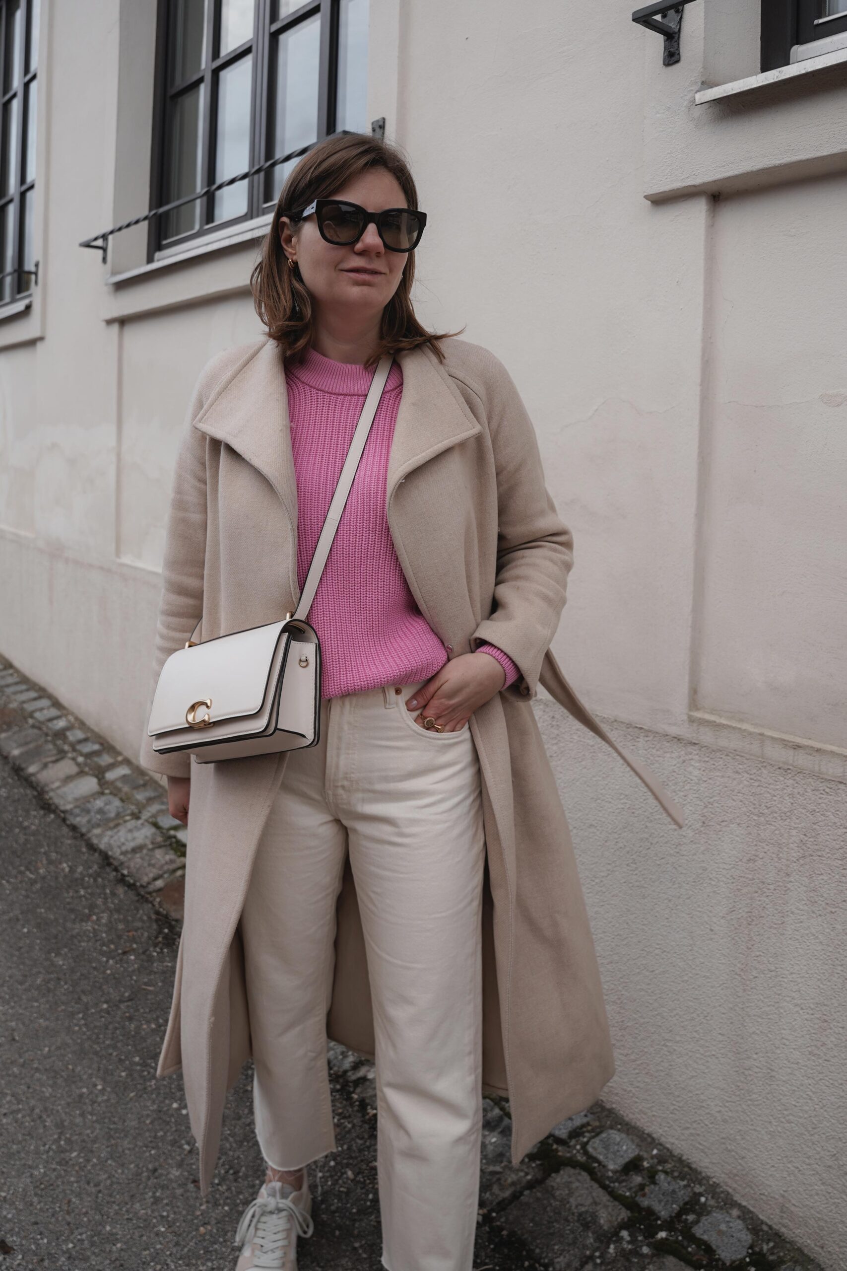 flared jeans, pink sweater, beige winter coat, mango, coach bag, casual