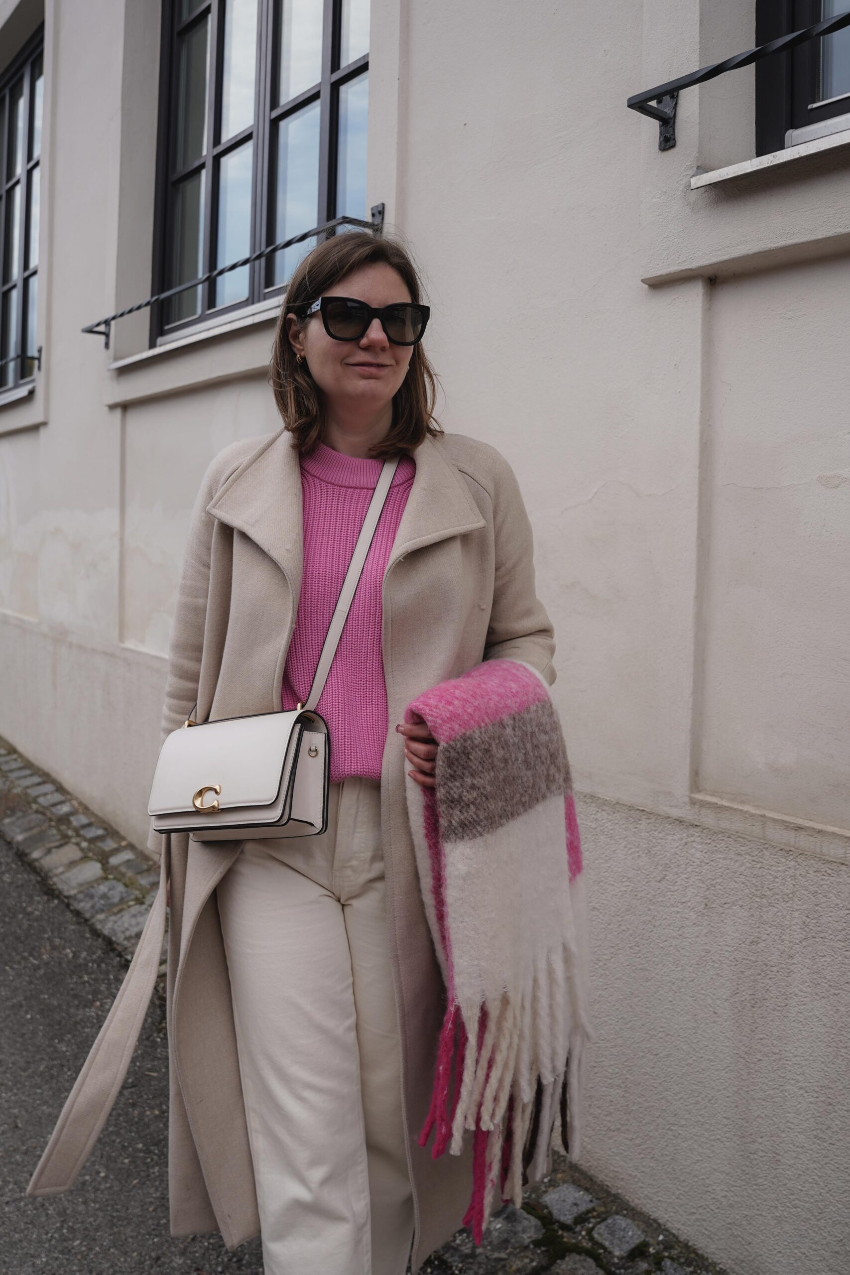 flared jeans, pink sweater, beige winter coat, mango, coach bag, casual